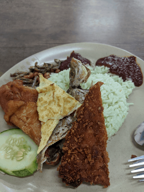 Nasi Lemak with assorted toppings and mint green pandan rice at Interim Market Hawker Centre. Photo credit: Shuya Araya.