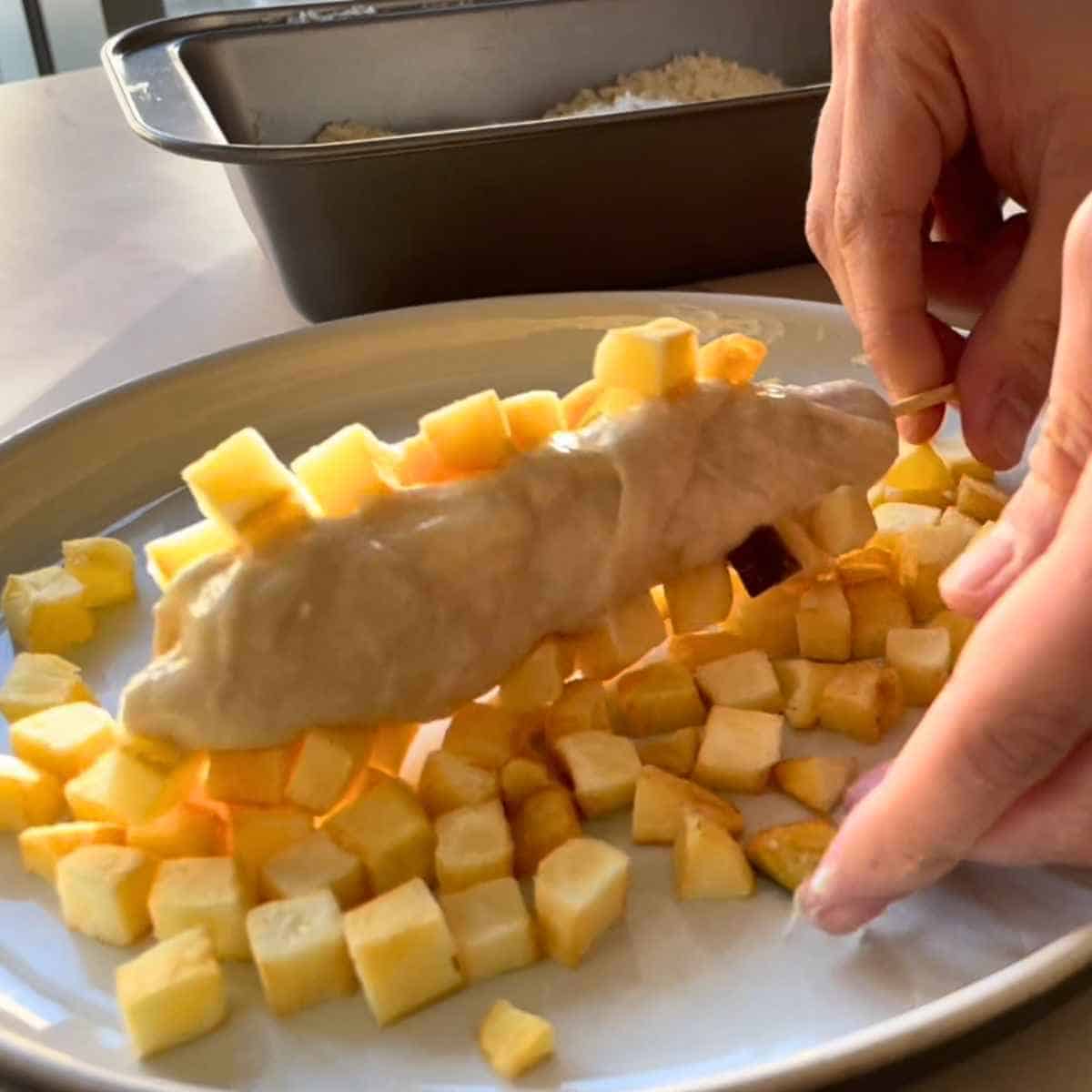 Rolling potatoes with batter
