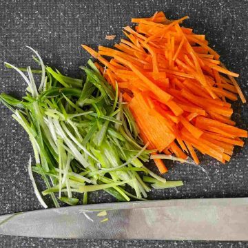 Cut green onion carrots to long strips
