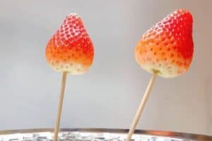 Dry out and skewer the strawberries on sticks