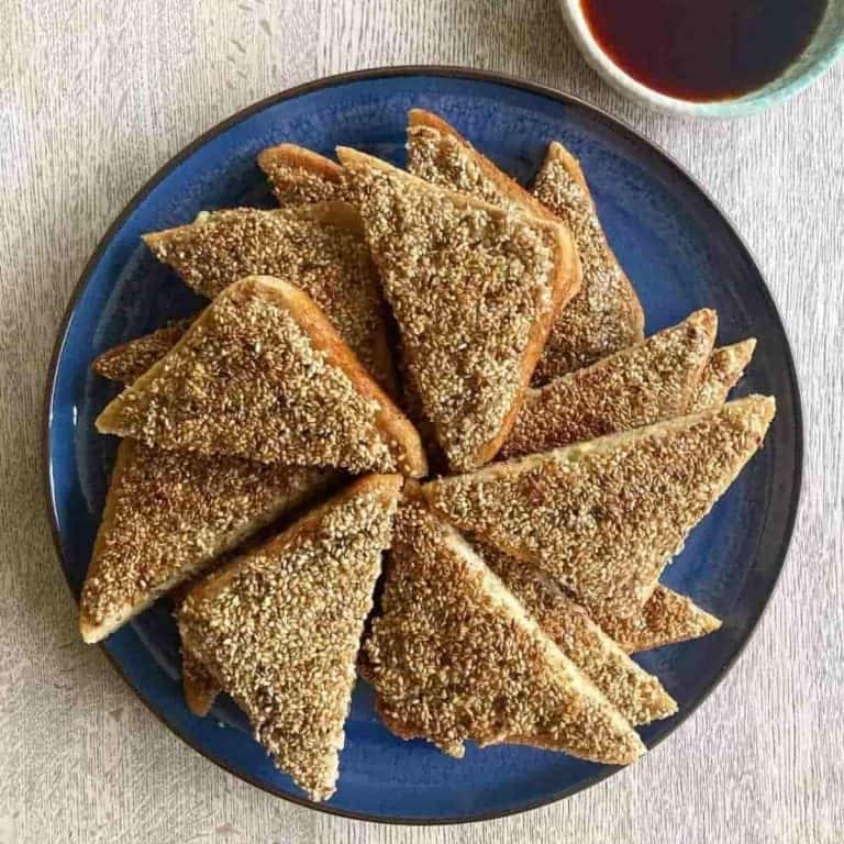 Prawn toast recipe sesame on blue plate with sauce on the side