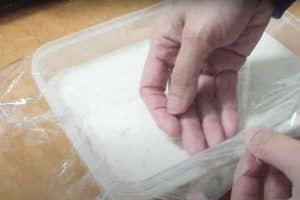 Press the saran wrap on the surface of the ice cream before freezing