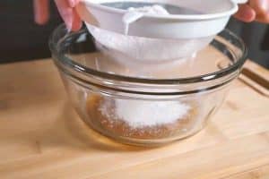 Sieve flour to add to syrup and lye water
