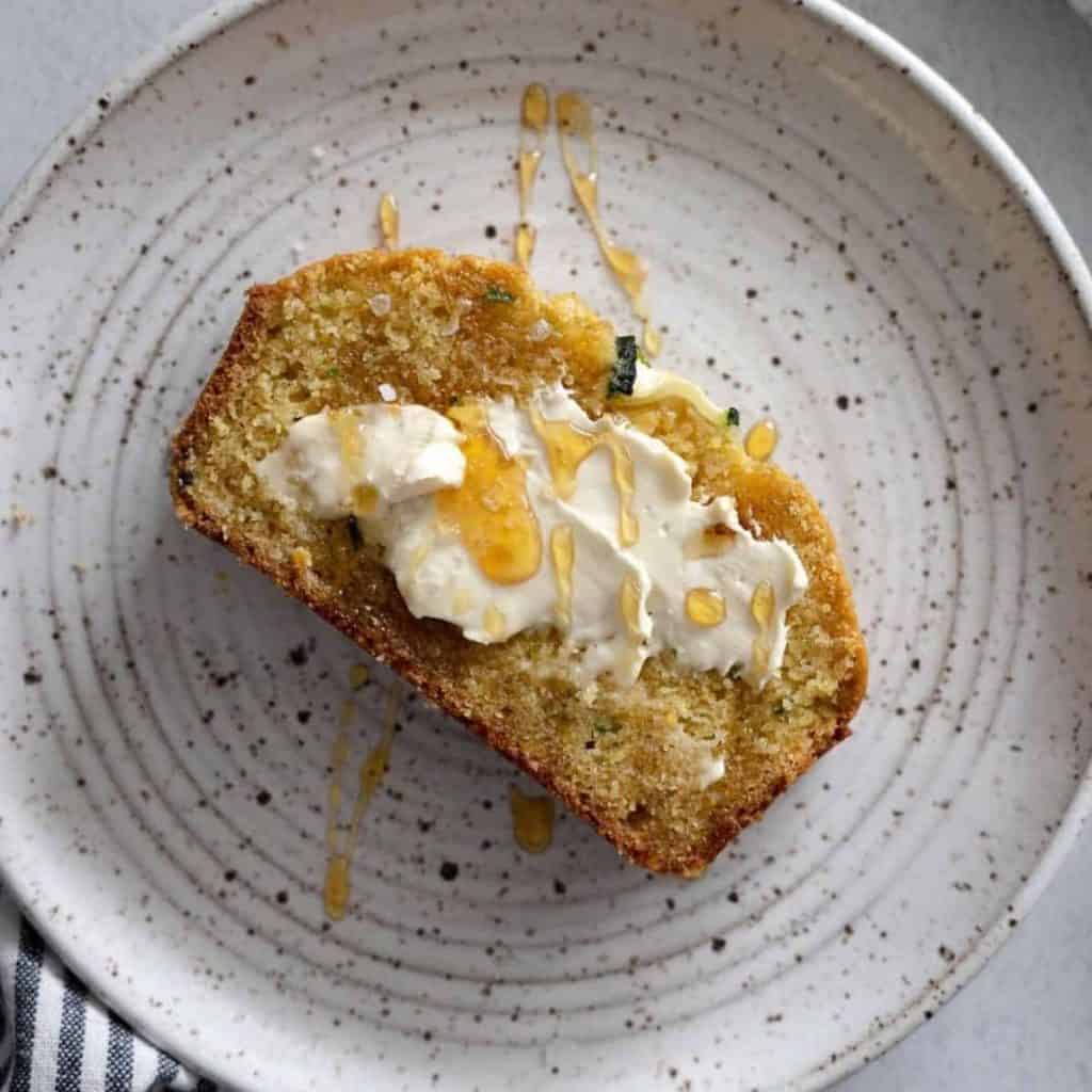 Zucchini cornbread topped with butter and salted honey