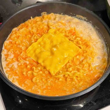 Add sliced cheese on top cheese ramen mix