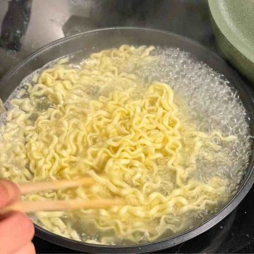 Boil instant noodles in pan