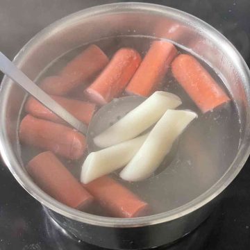 rice cakes and hot dog in boiling water