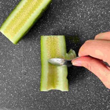 spoon out seeds in cucumber