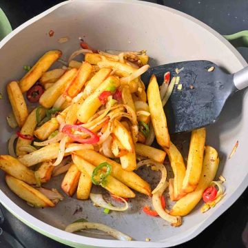 Add in fries to salt and pepper mix