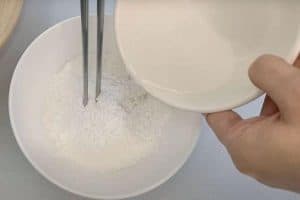 Pour water into a bowl of glutinous rice flour to mix