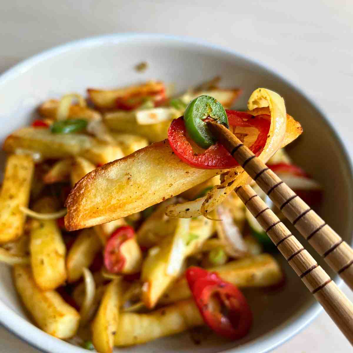 chinese salt and pepper fries in chopsticks