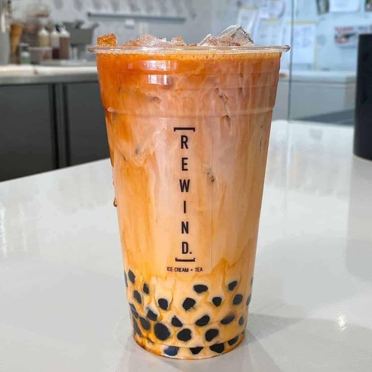 A cup of Thai tea mixed with milk, topped with ice