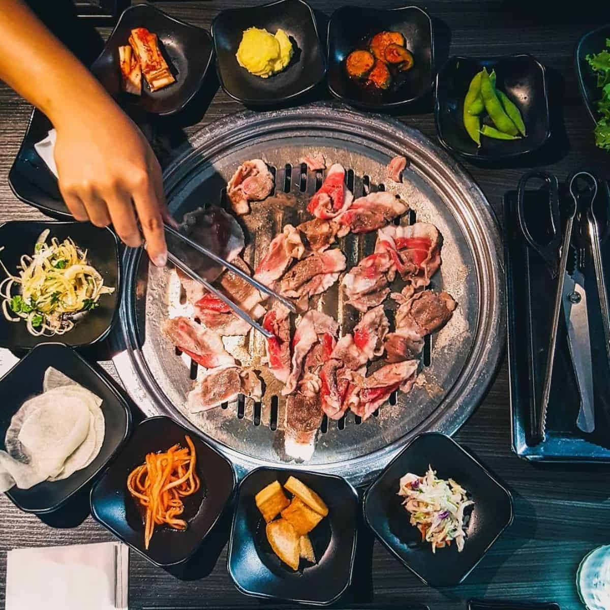 Birds eye view of Korean BBQ with side dishes