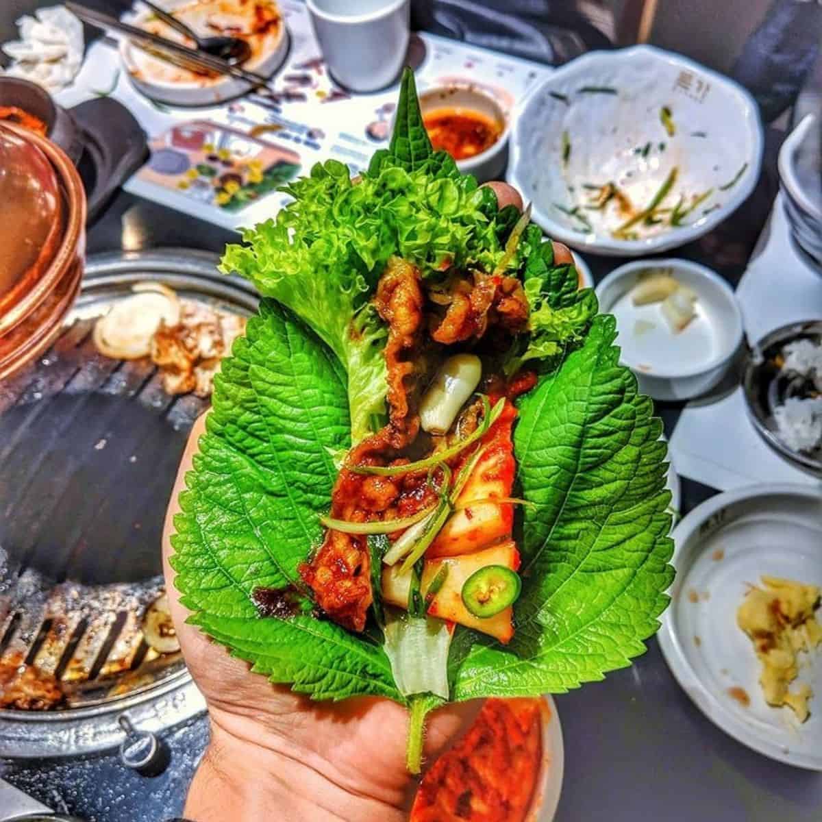 Marinated beef brisket with kimchi, lettuce and perilla leaf
