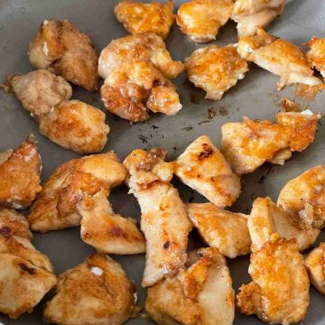 battered chicken breast fried in pan