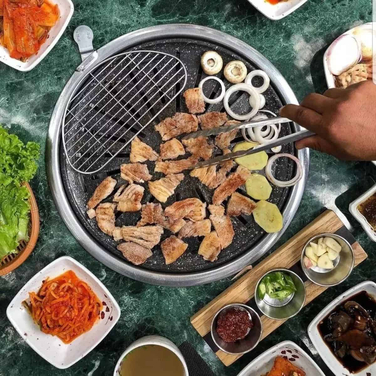Samgyeopsal on grill with onions and mushroom