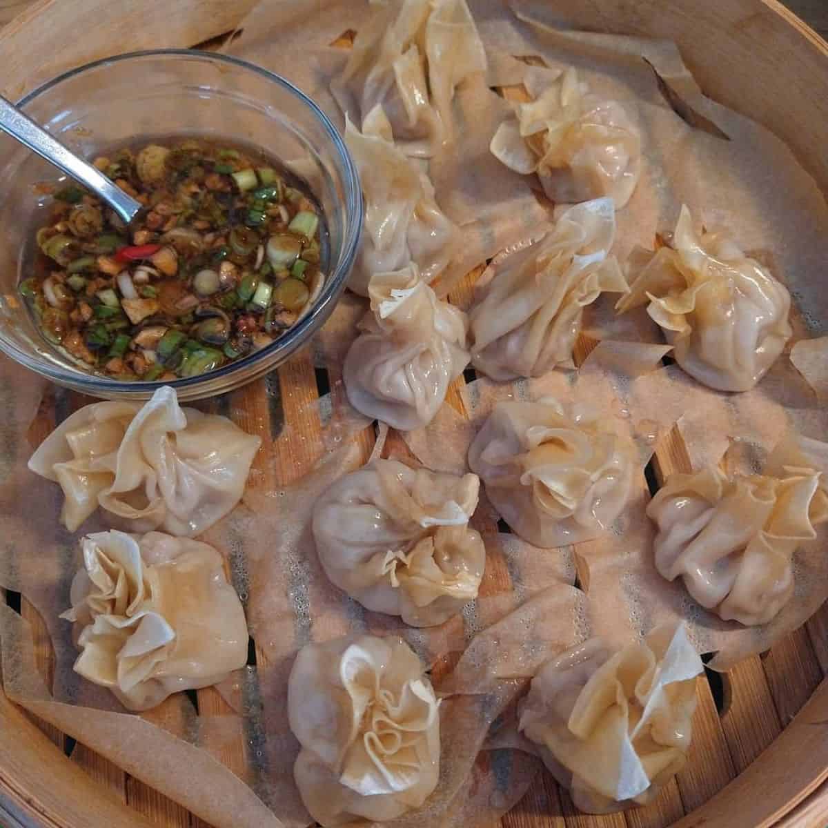 Steamed dumplings with a side of dipping sauce