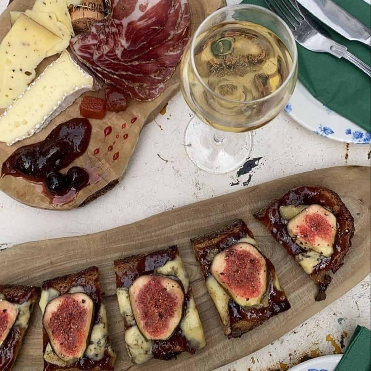 Tartine with blue cheese & fresh figs, solid cheeseboard and glass of champagne