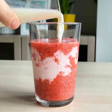 Add strawberry puree and milk to glass