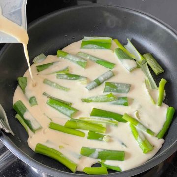 Pour pajeon batter over green onions