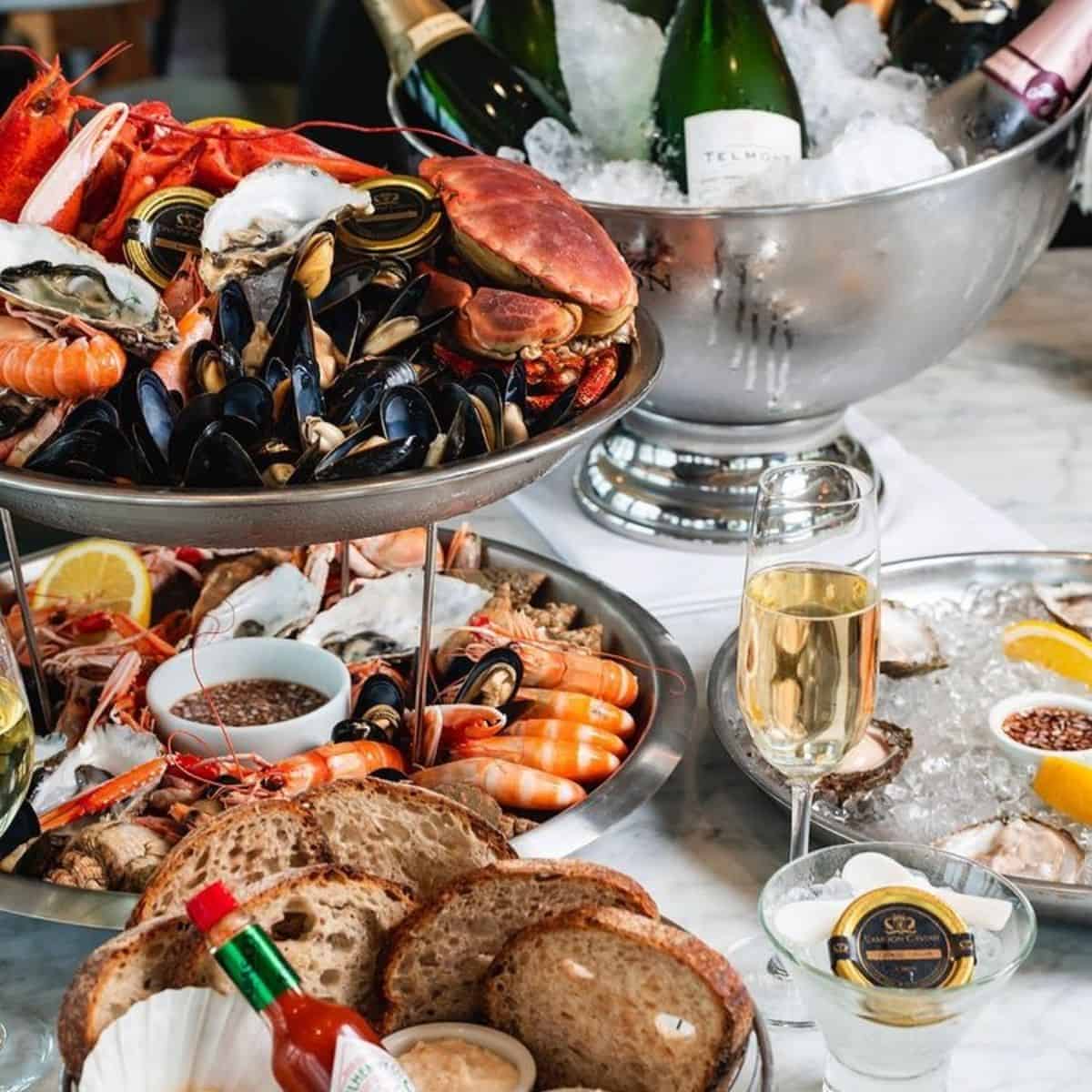 full seafood platter with seafood, bread, cheese and wine Riddle and Finns