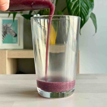 pour blueberry puree into glass
