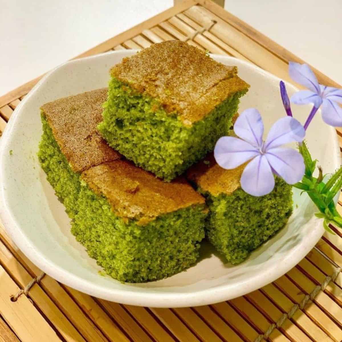 Cube slices of green tea treat on a bamboo rack