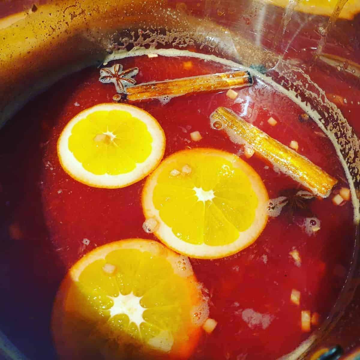 Christmas spiced drink mixture with lemon, star anise, and cinnamon stick