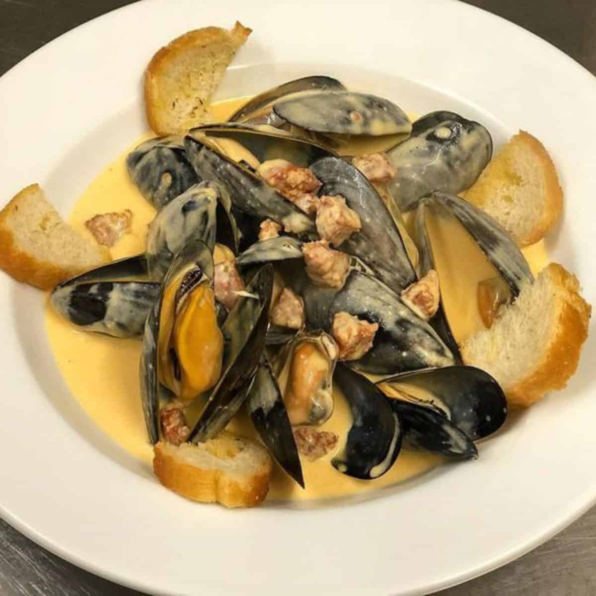 A delicious plate of Mussels with chorizo and bread Semolina