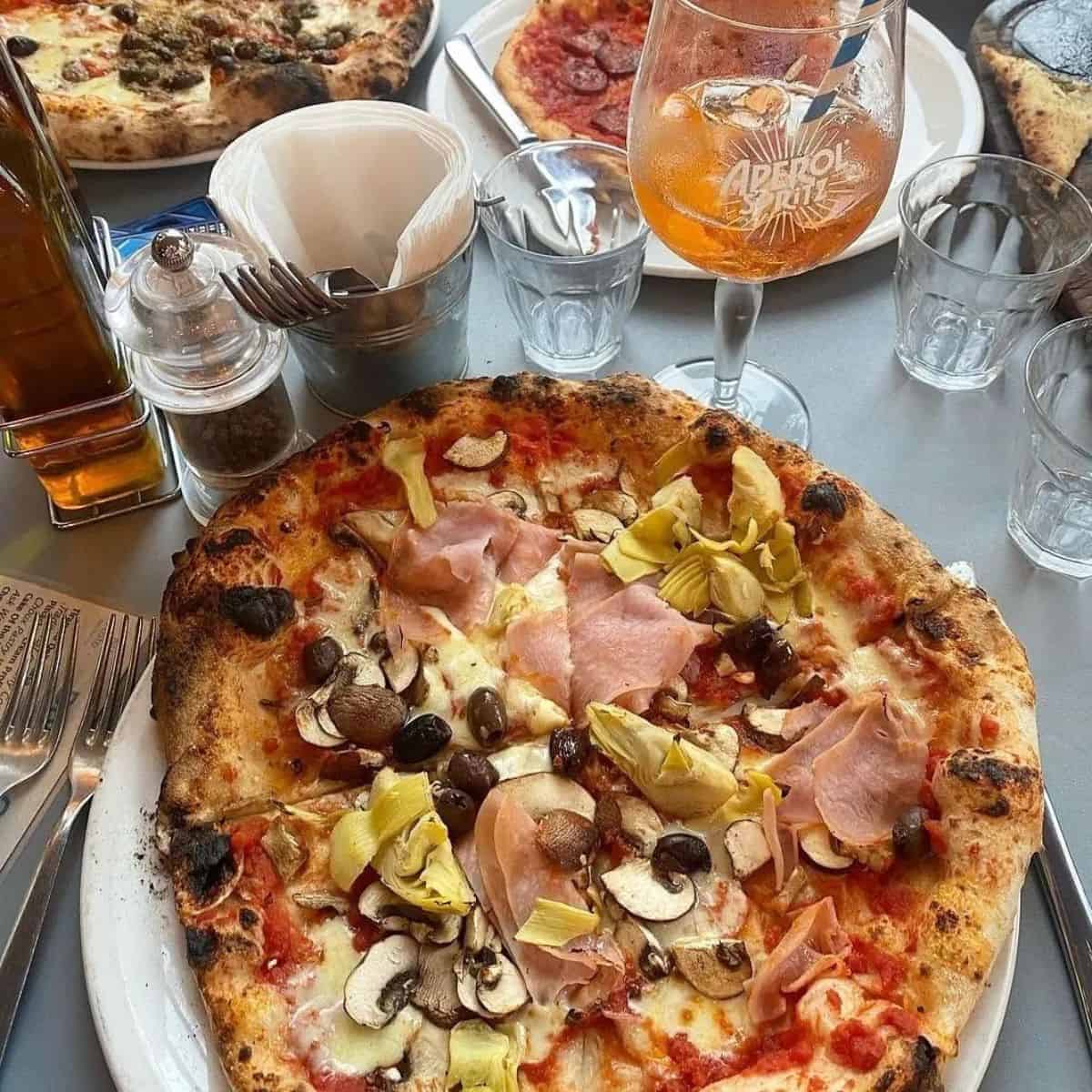 Best  Italian restaurant in Brighton Neapolitan Pizzeria with a mushroom on top and Aperol spritz on the side 
