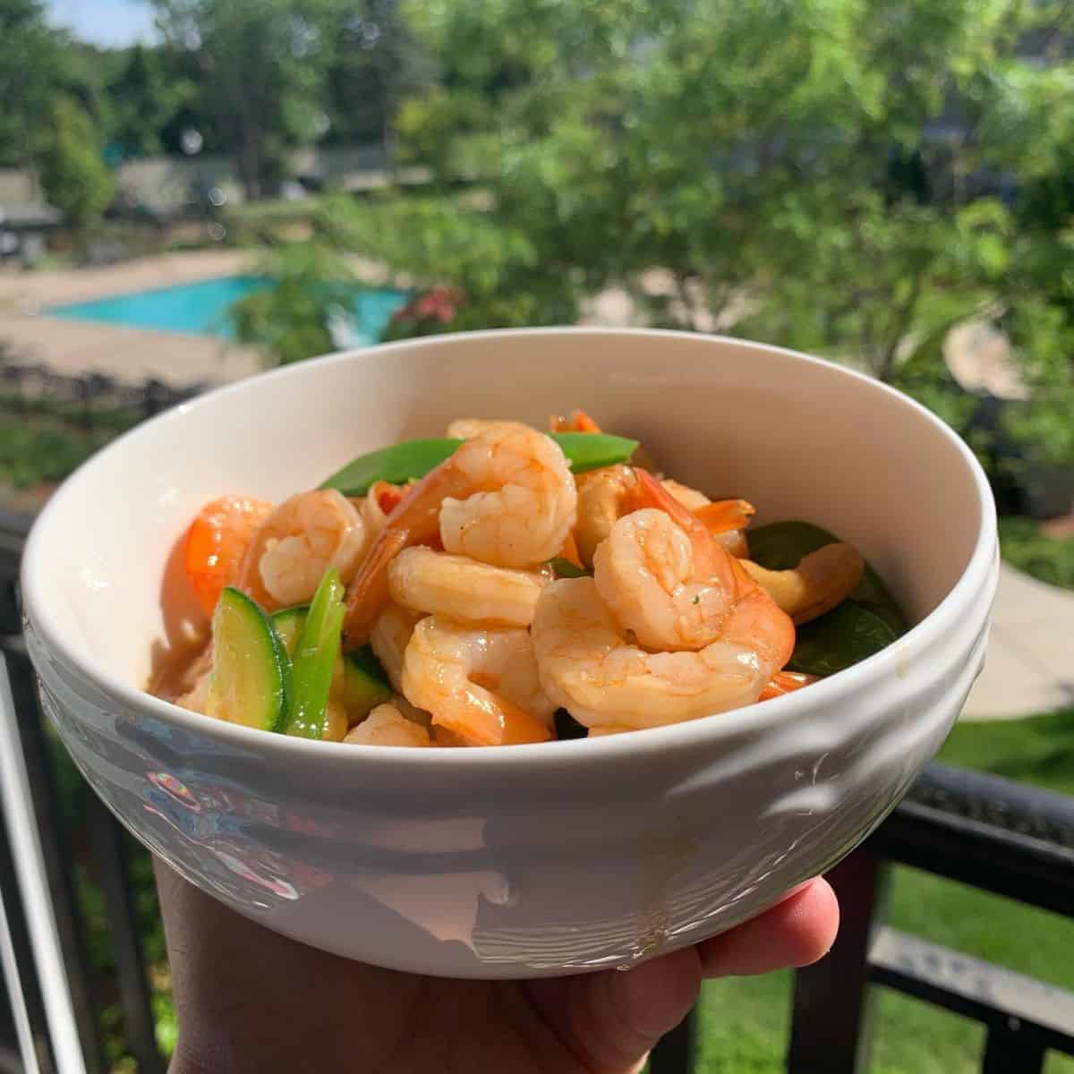 Outdoor shot of Keto Kung Pao Shrimp served in a white bowl