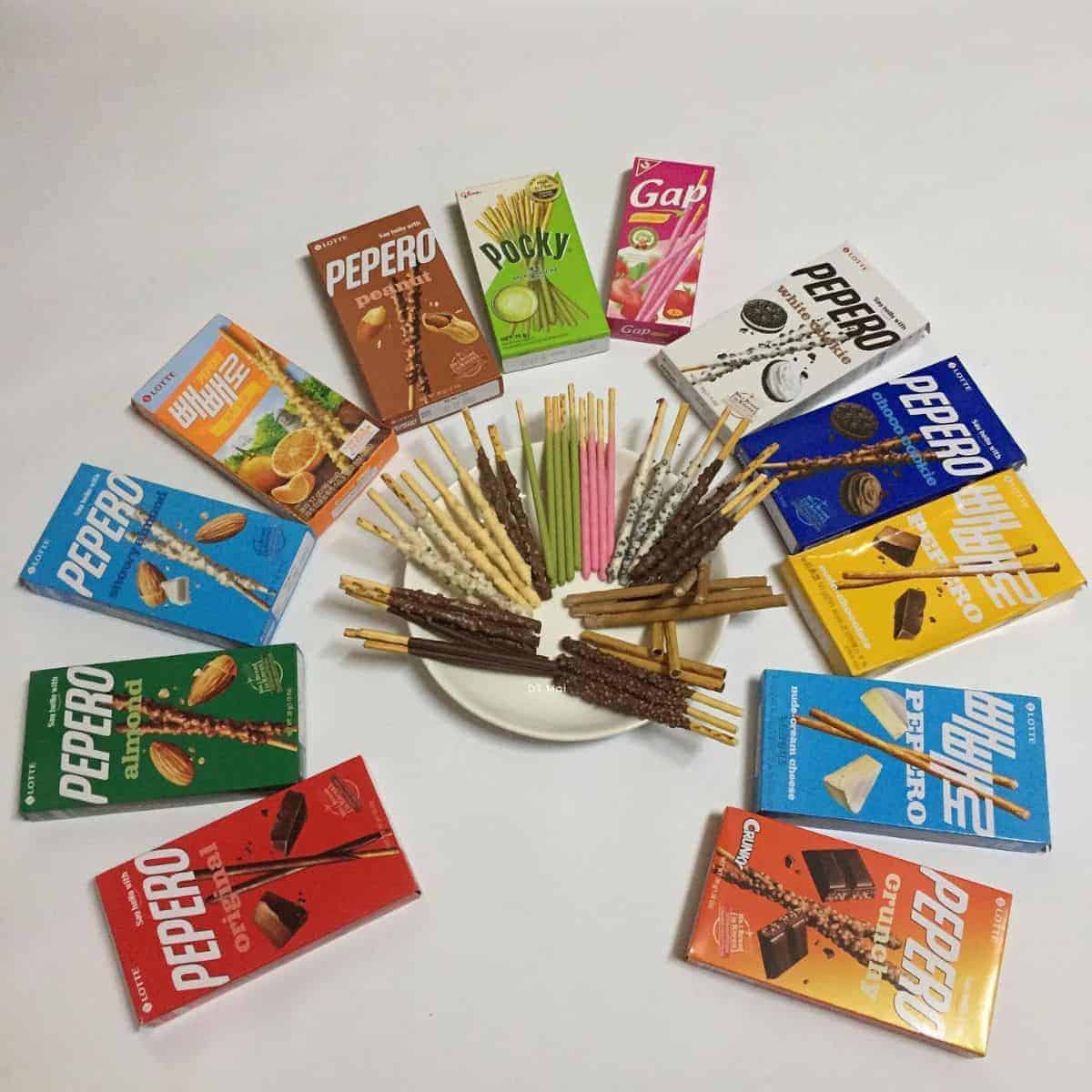A plate full of Pepero in different flavours encircled by Pepero boxes halal korean snacks