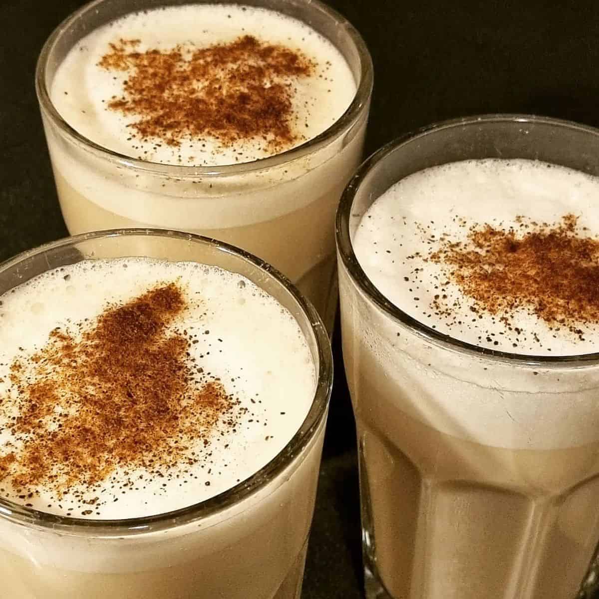 Three servings of luscious latte in transparent glasses