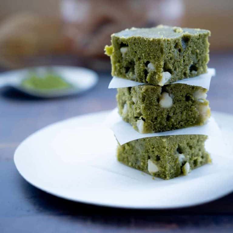 healthy matcha brownies recipe stacked on wooden board