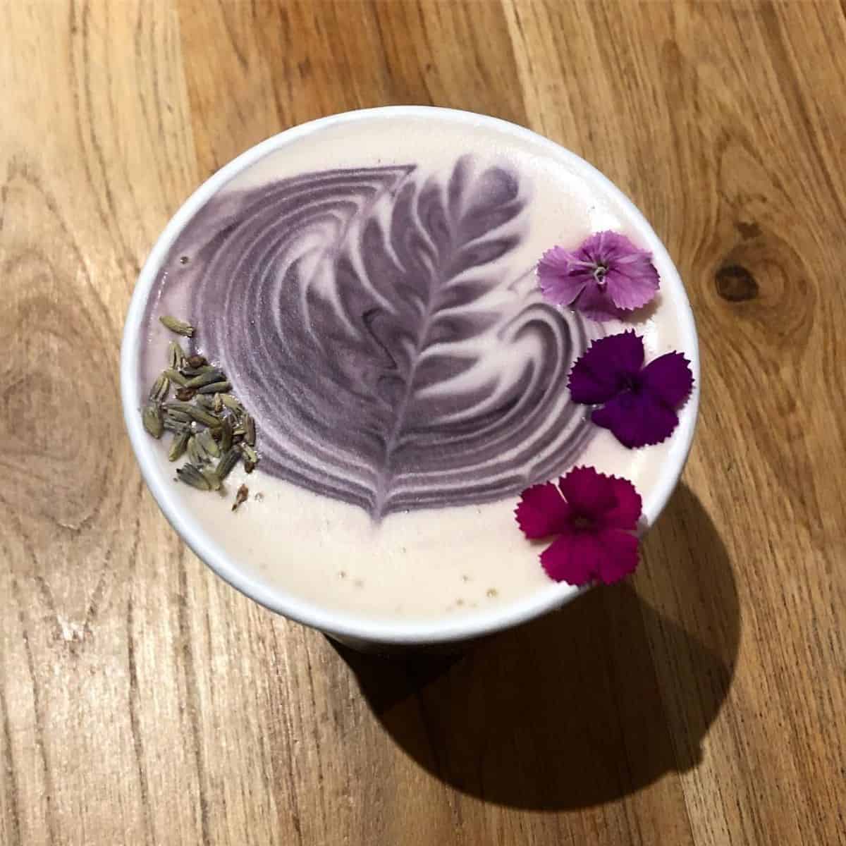 avender Milk Tea adorned with three different purple shades of flowers