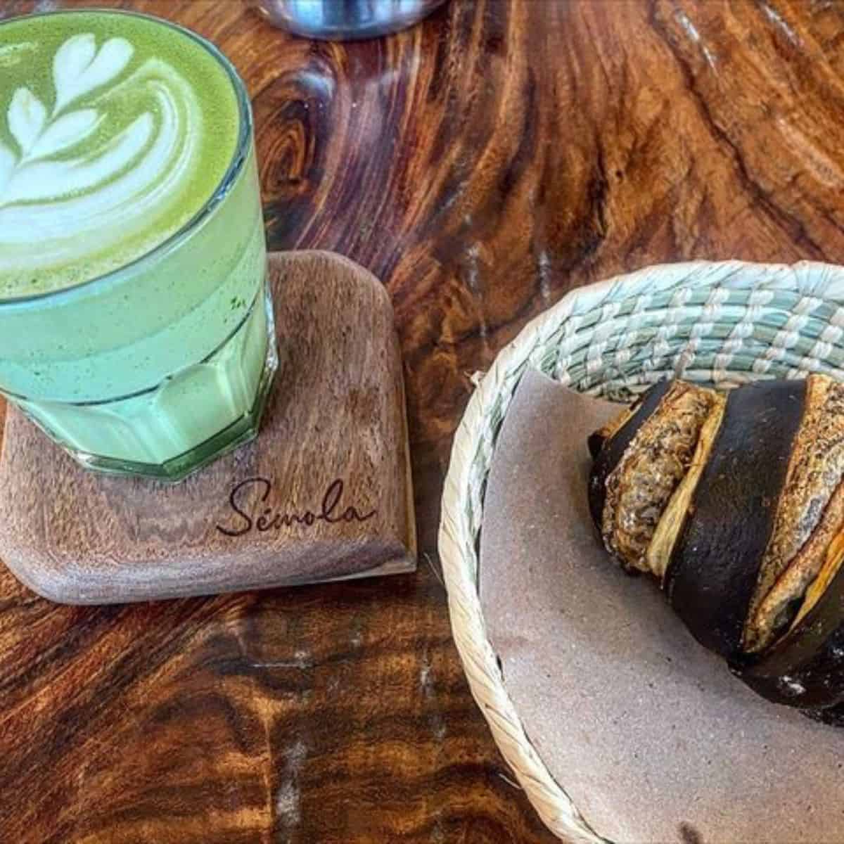Mouthwatering Matcha Latte paired with croissant in dark brown stripes