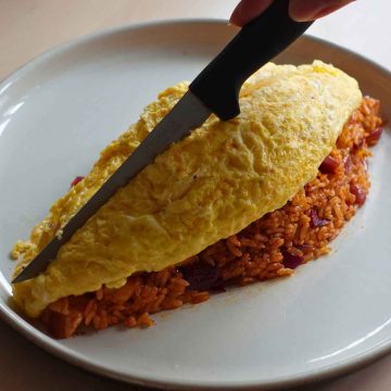 cutting open the omelette using knife