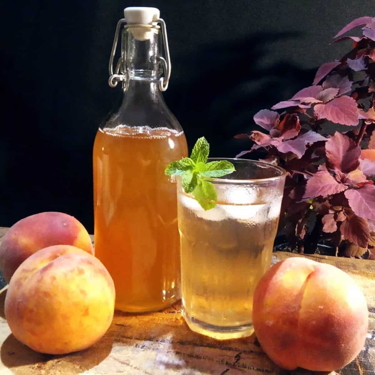 Peach syrup, fresh peaches, and a cold glass of drink