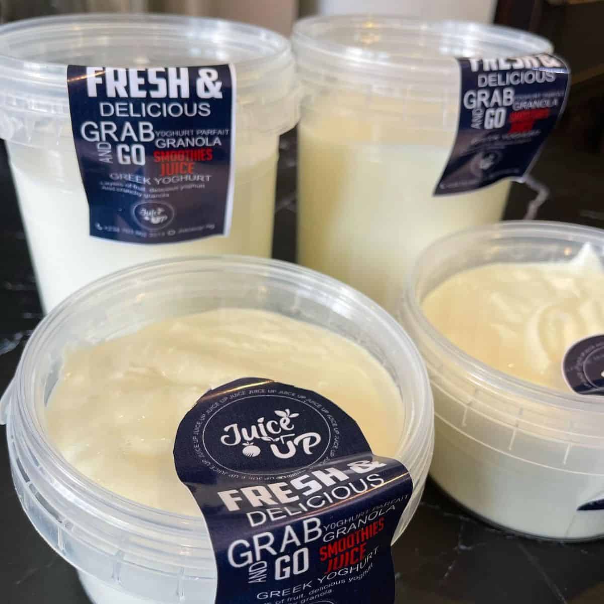 Transparent and plastic storages filled with greek yoghurt