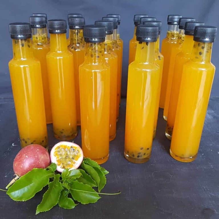 Passion fruit syrup bottles with fresh pulp passion fruit on the side