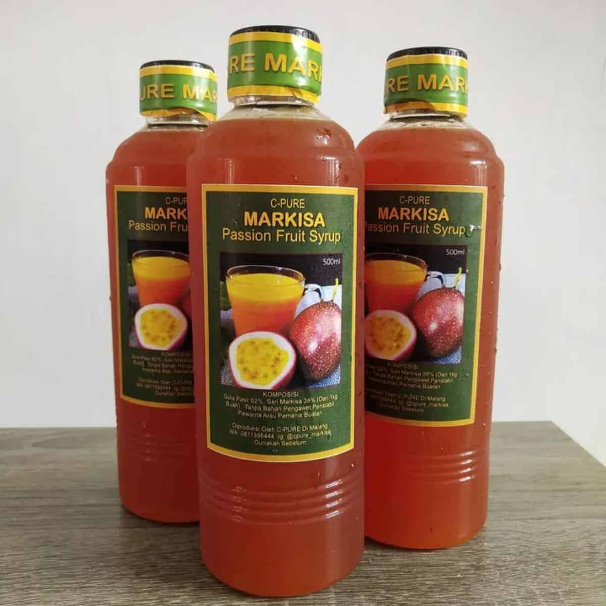 Three bottles of passion fruit syrup on display to be used as a natural sweetener to boba  drink.
