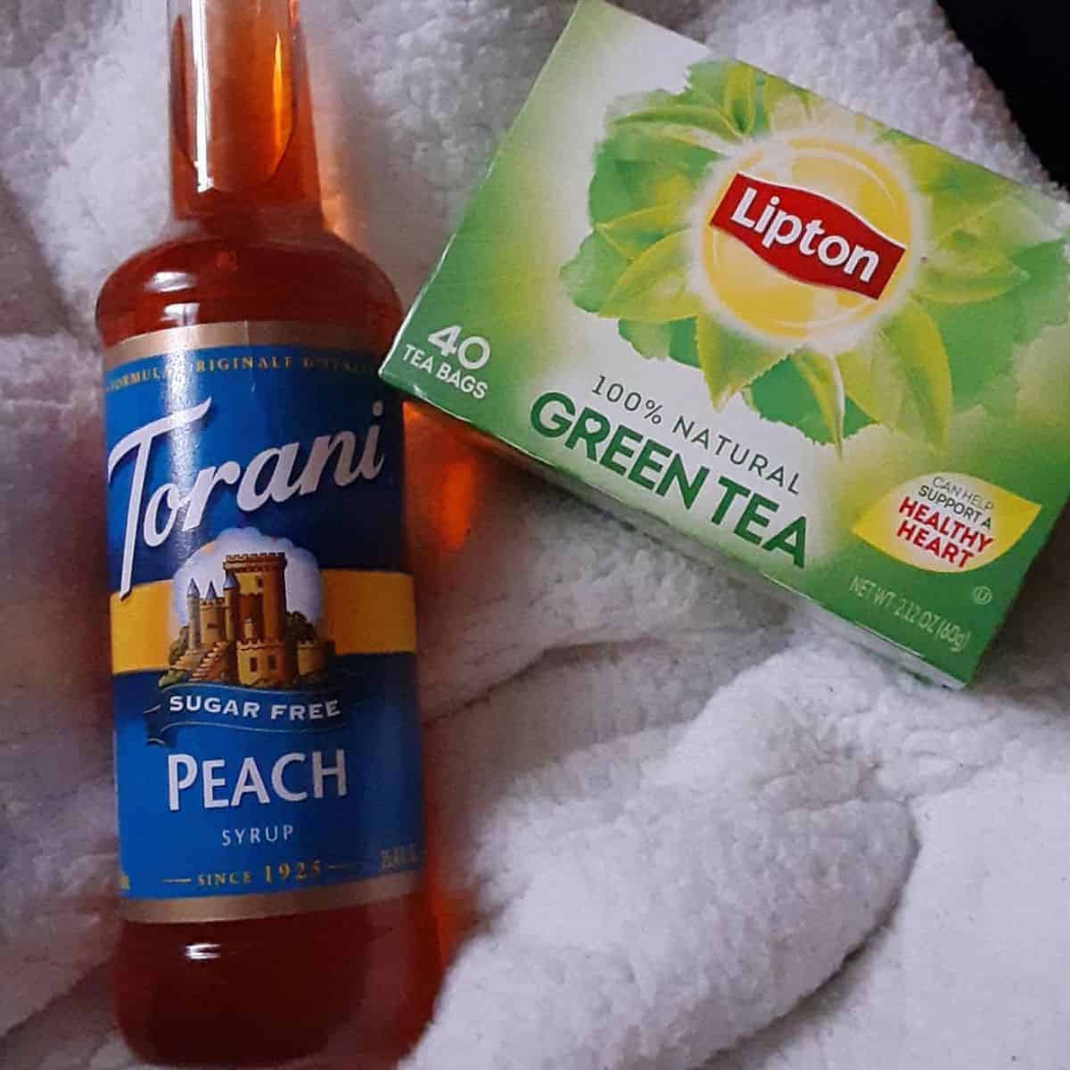 One bottle of Torani sweetener and a box of green tea