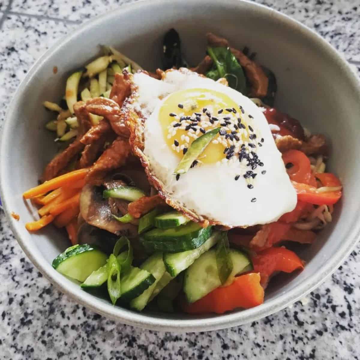 A delicious bowl of bibimbap which is a little different from Dosirak