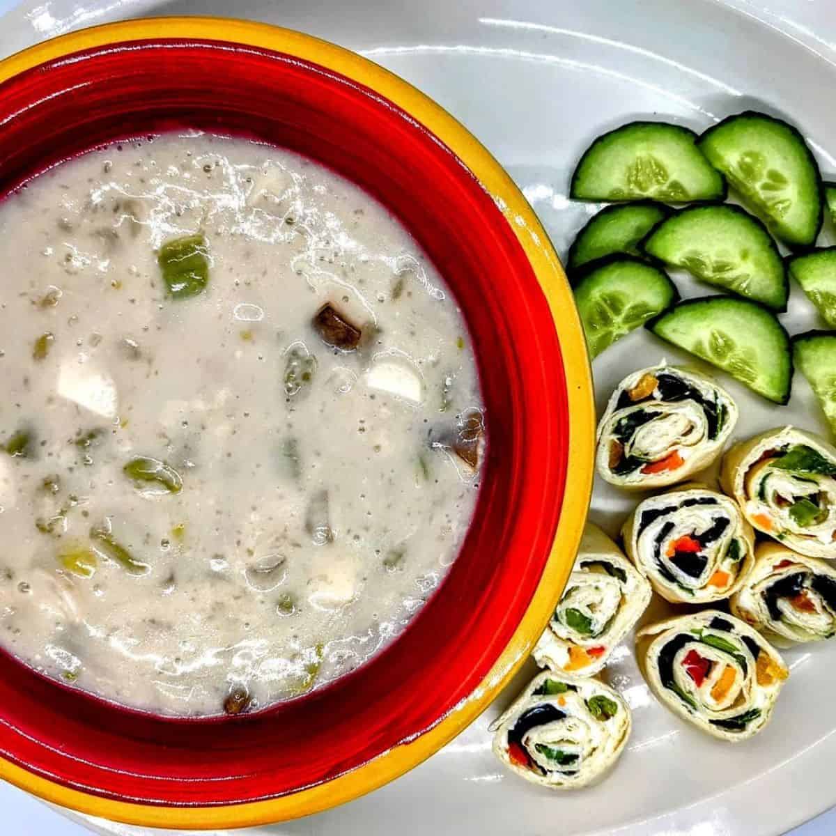 Flavourful cream of mushroom and celery soup in a red bowl