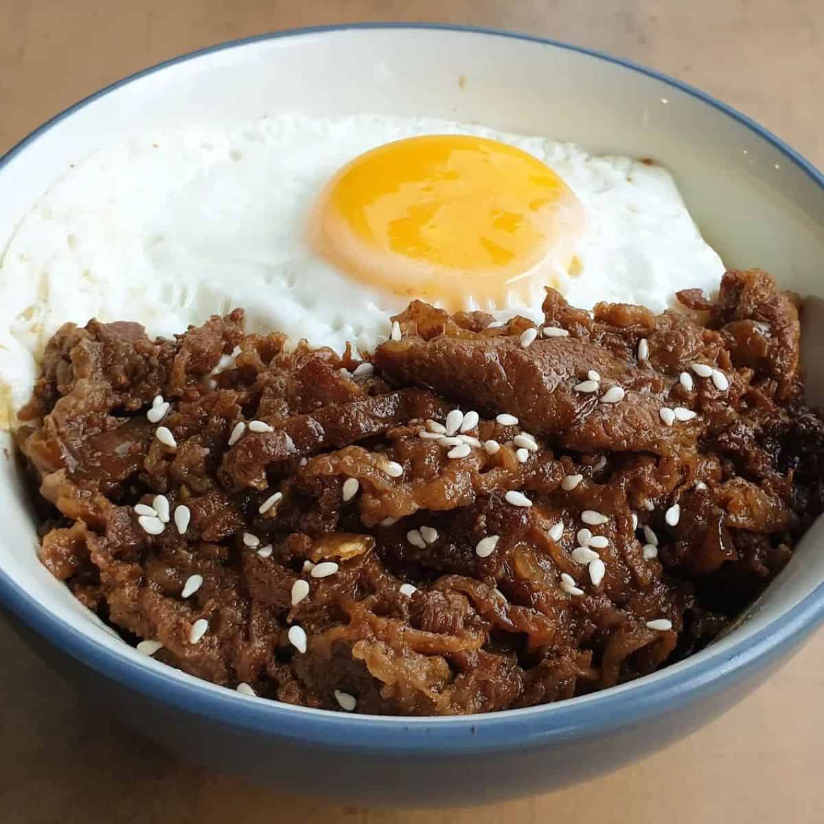 Beef Teriyaki sprinkled with sesame seeds and paired with a fried egg