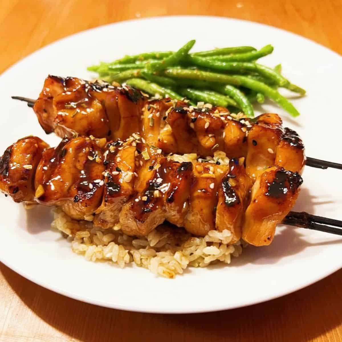 Delicious Teriyaki chicken skewers with green beans and brown rice