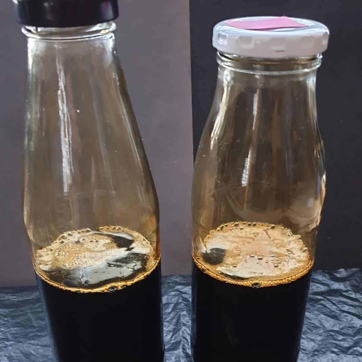 Dark brown liquid in two sealed bottles