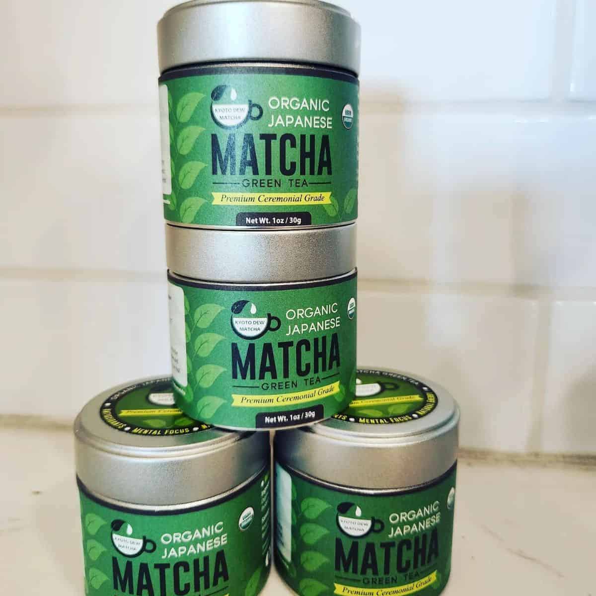 Stacked four small bottles of matcha powder