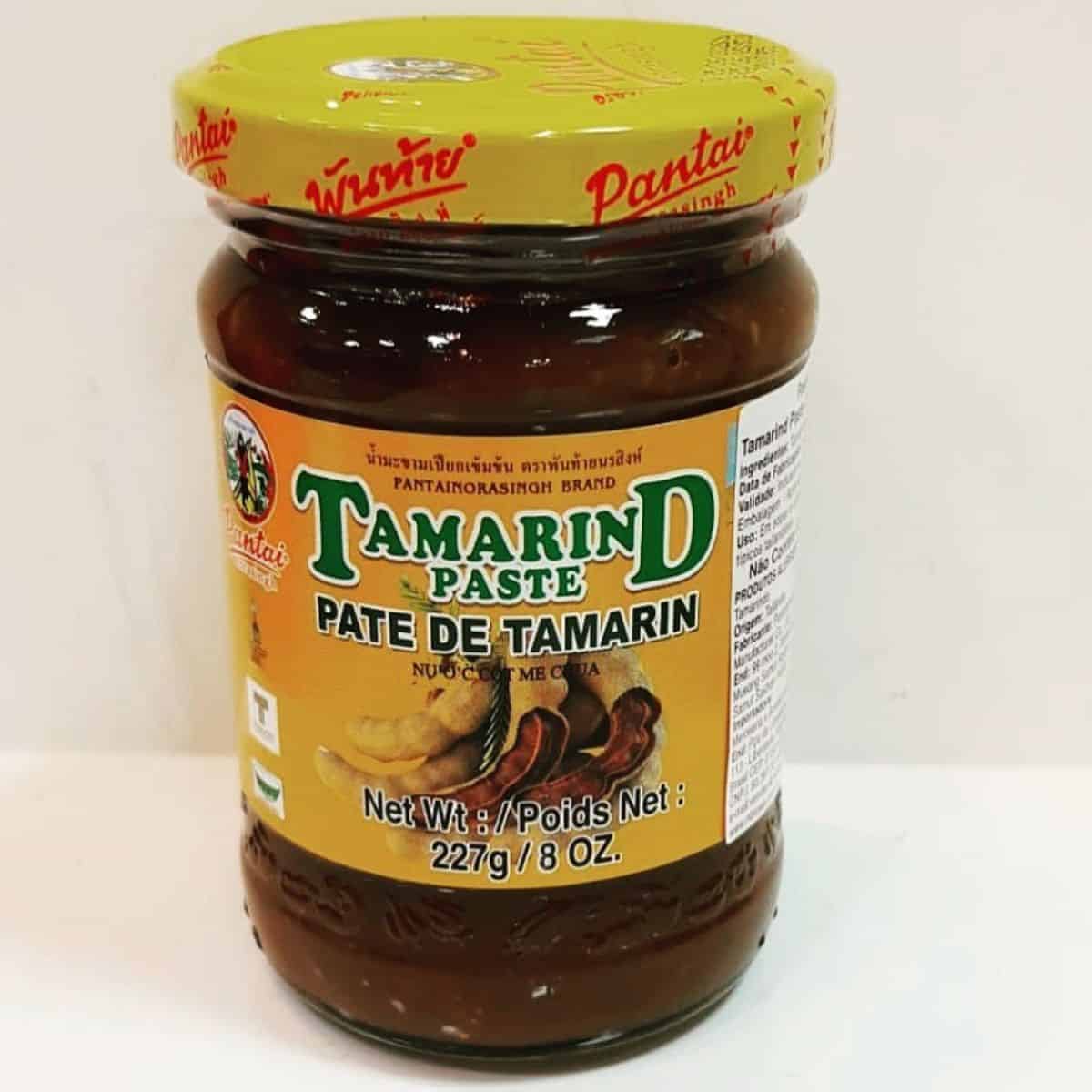 Bottled Tamarind paste with yellow tag and seal.