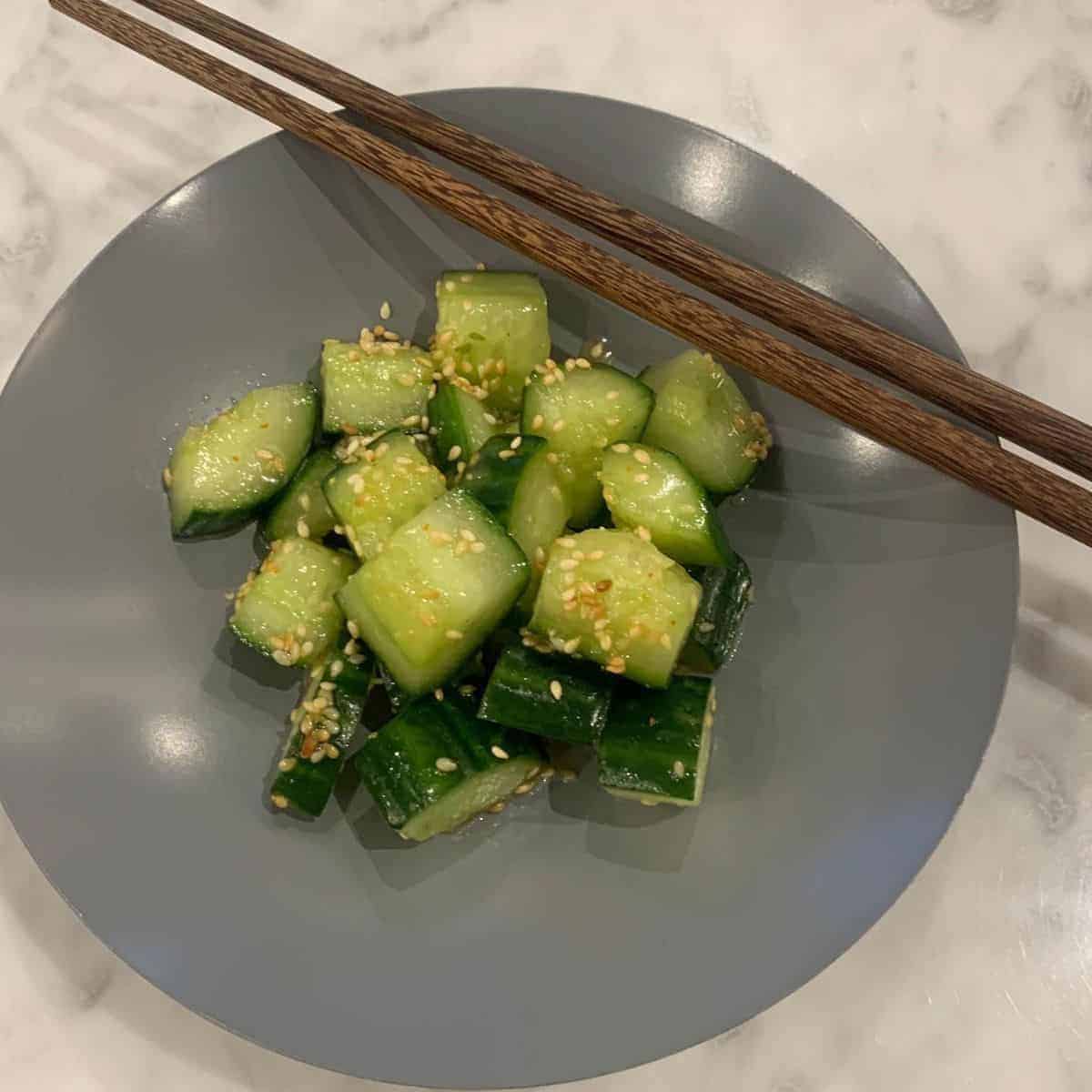 Slightly thick slices of green veggie topped with sesame seeds